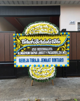 Papan Bunga Duka di Dorong